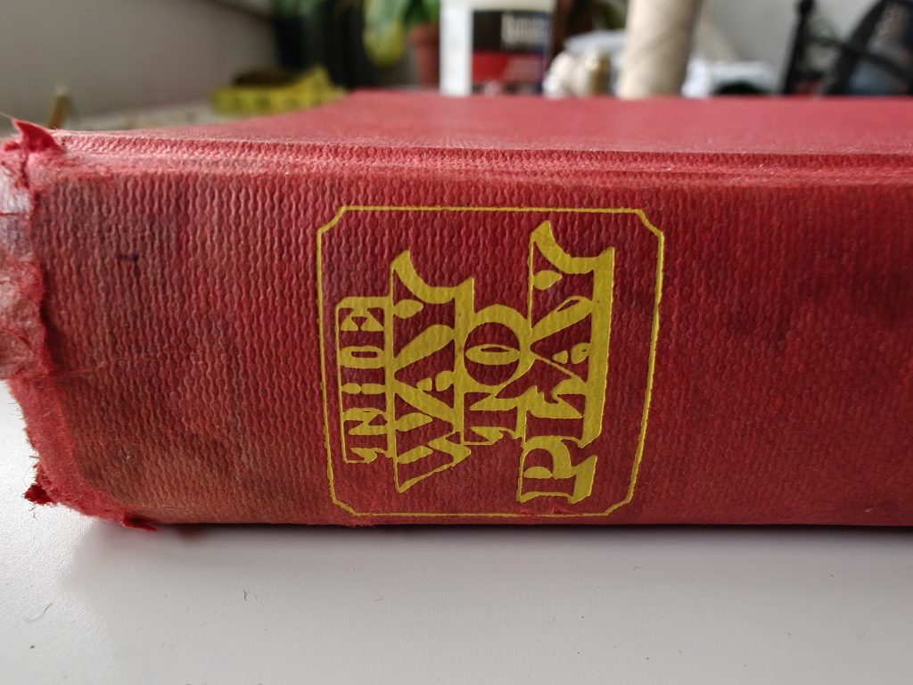Spine of red hardback book with the words "The Way to Play" printed in gold inside a gold square