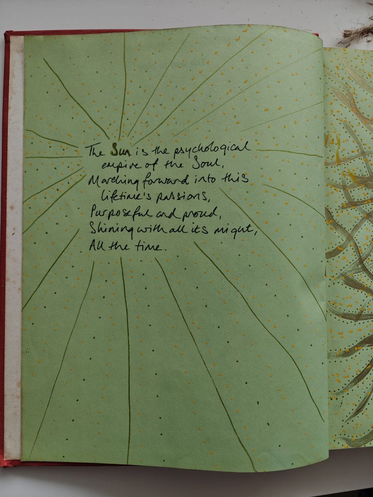 Words of a poem written in black ink script on the green page of a book, with lines of gold and dots of yellow paint emanating from the words to the edges of the page